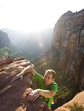 A man climbing up a rock at Red Rock