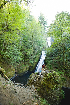 Hikers in front of waterfall