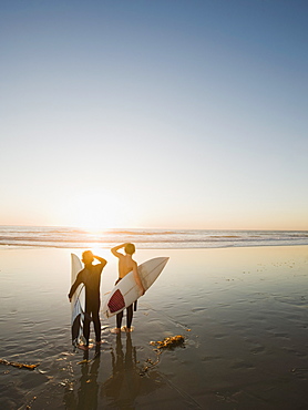 Kids on beach with surfboards