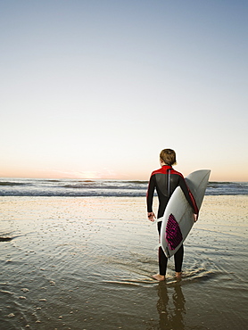 Child holding surfboard