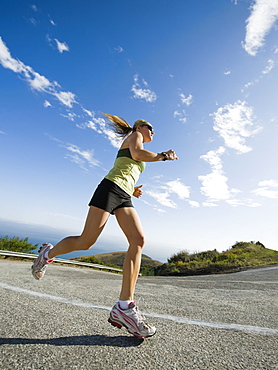 Woman running on a road in Malibu