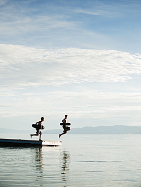 Boys (10-11,12-13) jumping from raft