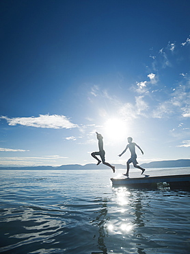 Boys (10-11,12-13) jumping from raft