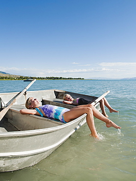 Girls (6-7,8-9) resting on boat