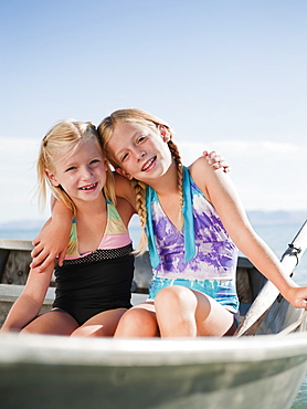 Girls (6-7,8-9) resting on boat