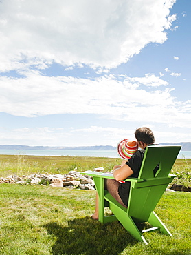 Father and daughter sitting (2-3) on chair and looking at view