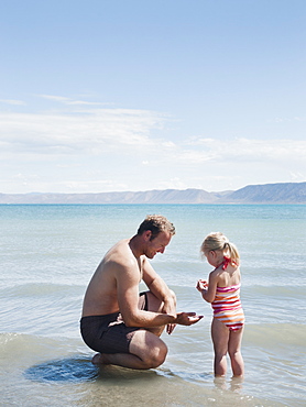 Father and daughter (2-3) at lake