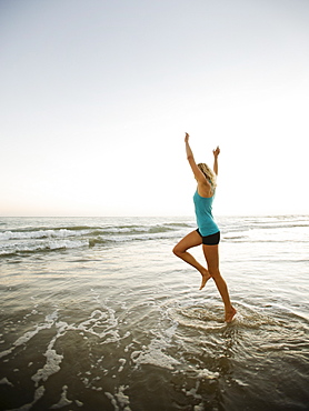 Portrait of woman running on beach