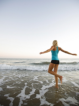 Portrait of woman running on beach