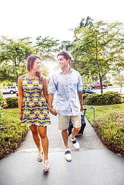 Couple walking, man pulling suitcase, USA, Washington, Everett 