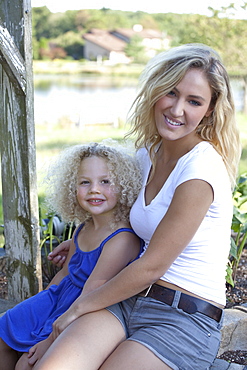 Mother with daughter (4-5) sitting outdoors, Old Wick, New Jersey