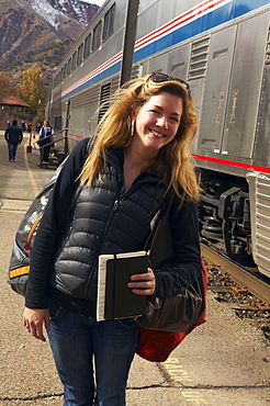 Woman smiling at train station, Glenwood Springs, Colorado, USA