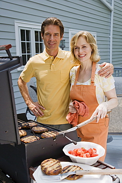 Family barbequing on deck