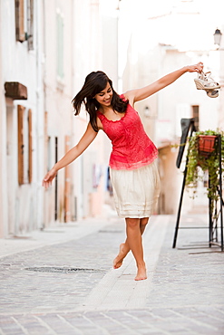 France, Cassis, Young woman balancing on curbstone, France, Cassis