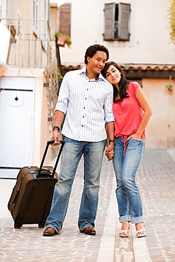 France, Cassis, Couple with suitcase holding hands, France, Cassis
