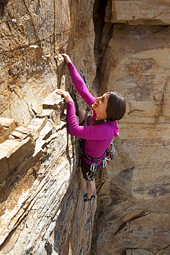 Smiling woman rock climbing