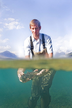 Man holding western cutthroat trout c, Lake McDonald, Glacier National Park, Montana, USA