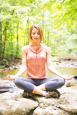 Woman practicing joga in forest, USA, New Jersey, Mendham