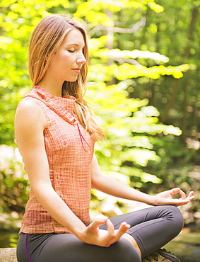 Woman practicing joga in forest, USA, New Jersey, Mendham