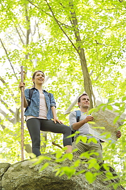 Couple hiking with map in forest, USA, New Jersey, Mendham