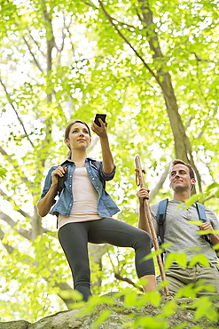 Couple hiking with GPS in forest, USA, New Jersey, Mendham