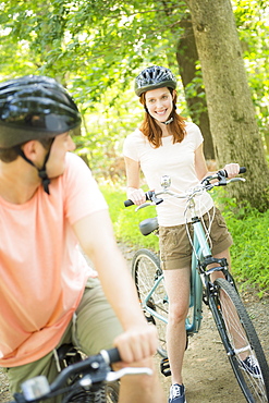 Couple cycling in forest, USA, New Jersey, Mendham