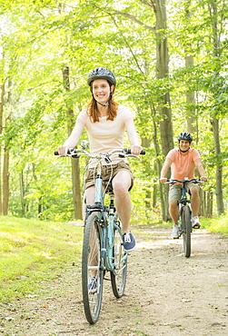 Couple cycling in forest, USA, New Jersey, Mendham
