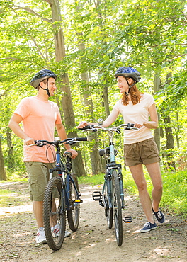 Couple cycling in forest, USA, New Jersey, Mendham