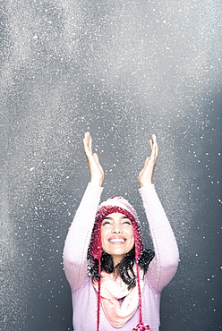 Cheerful woman wearing knit hat in winter