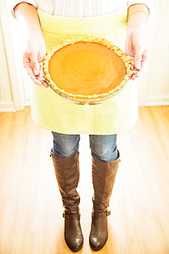 Woman holding pumpkin pie