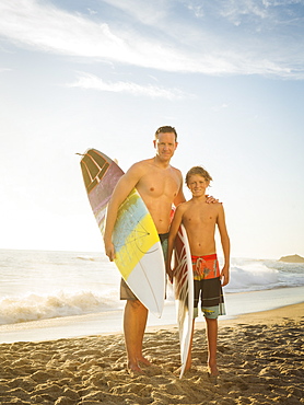 Portrait of father and his son (14-15) on beach, Laguna Beach, California