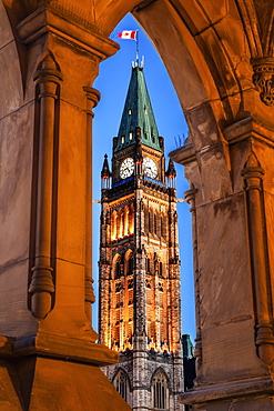 Illuminated Peace Tower seen through lancet arch, Ottawa, Canada