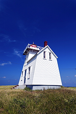 North Rustico Harbor Lighthouse against blue sky, Prince Edward Island, New Brunswick, Canada