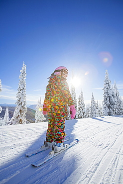 Girl (8-9) skiing in mountains, Whitefish, Montana USA