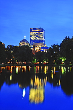 Office building reflecting in pond in Public Gardens at dusk, Boston, Massachusetts