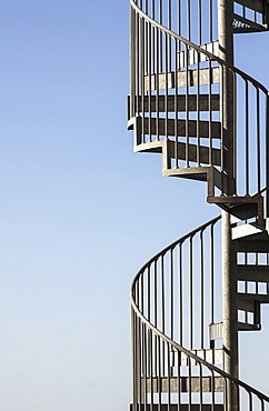 Metal stairway against blue sky