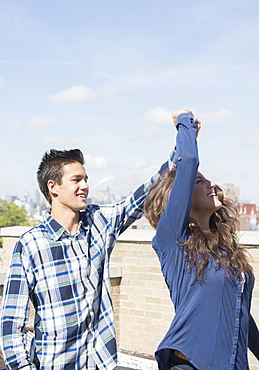 Young couple dancing on roof, Brooklyn, New York