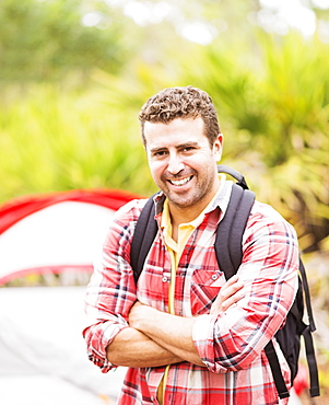 Portrait of man in front of tent with backpack, Jupiter, Florida