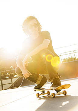 Man crouching on skateboard, West Palm Beach, Florida