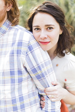 Young smiling woman next to boyfriend