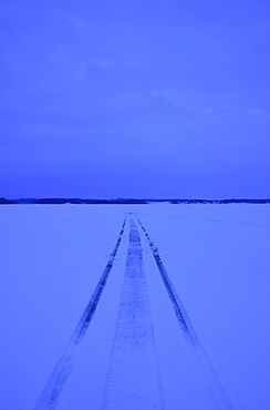 Snowmobile tracks on frozen lake, USA, New York State, Lake Champlain