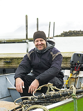 Portrait of man in boat, Rockaway Beach, Oregon