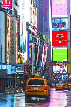 New York City, Car driving through street illuminated by neon lights