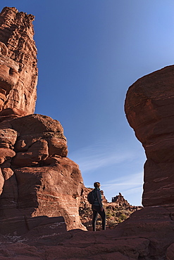 Woman standing by Fisher Towers in Utah, USA