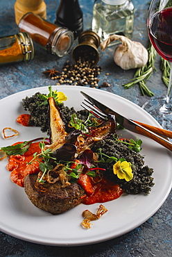 Meal of beef with vegetables and flowers