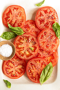 Sliced tomatoes with basil and salt