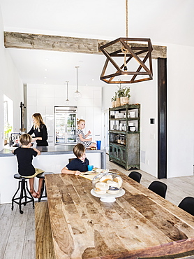 Mother and children in kitchen and dining room