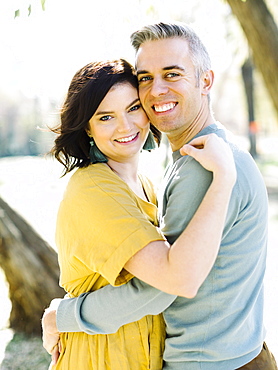 Smiling mid adult couple embracing in park