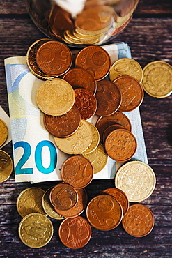 Euro coins on twenty Euro note