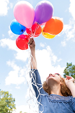 Girl holding balloons